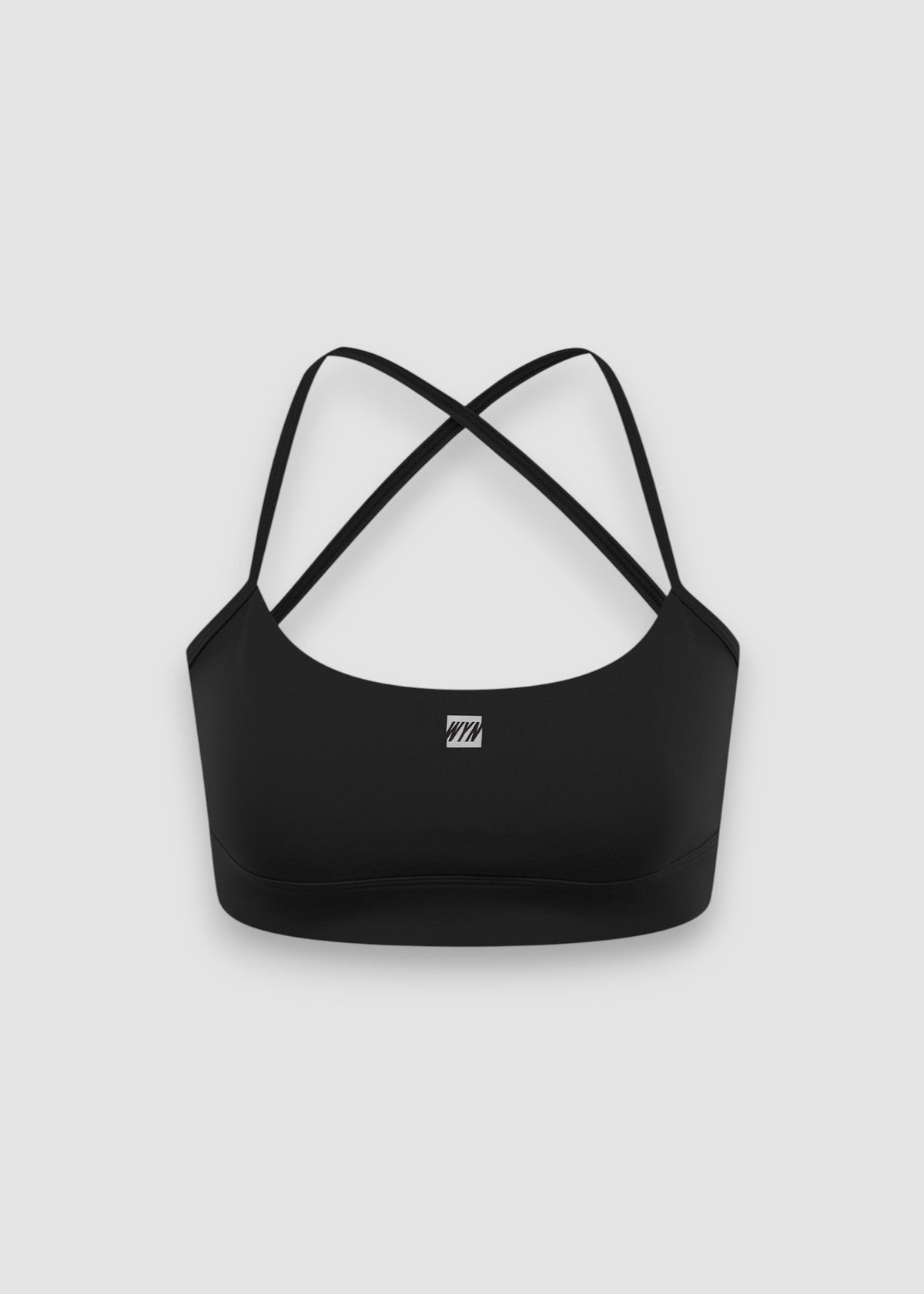 Black sports bra with criss-cross straps on a light gray background
